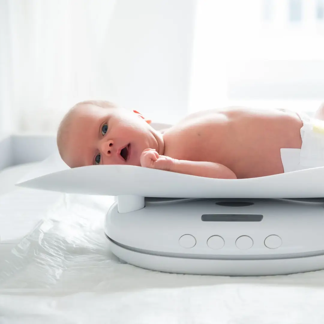 Baby op weegschaal nieuwe groeicurven