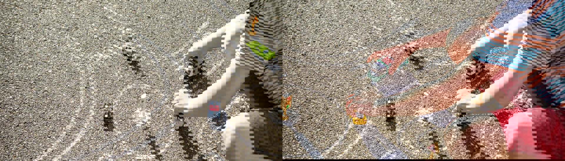 Jongen speelt op straat met auto's: Verkeer op kindermaat