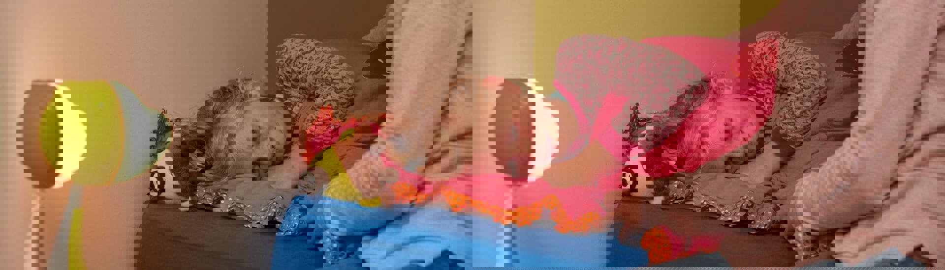 Ouder probeert te praten met kind dat in bed ligt